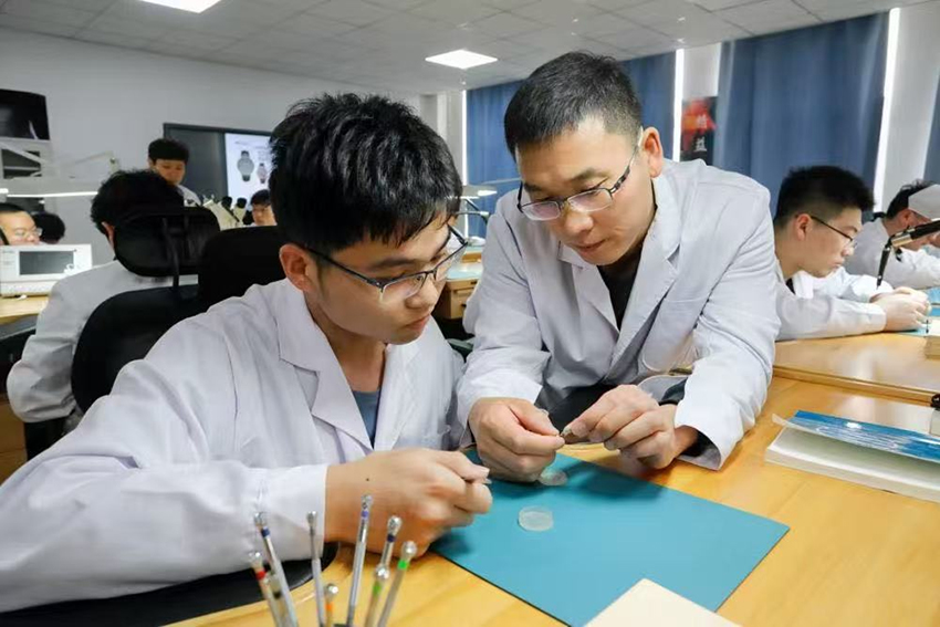 师生共同分析已装配完成的计时机芯工作状态。WilliamHill官方网站供图